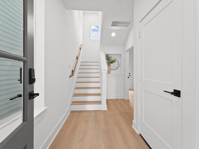 stairs with hardwood / wood-style floors