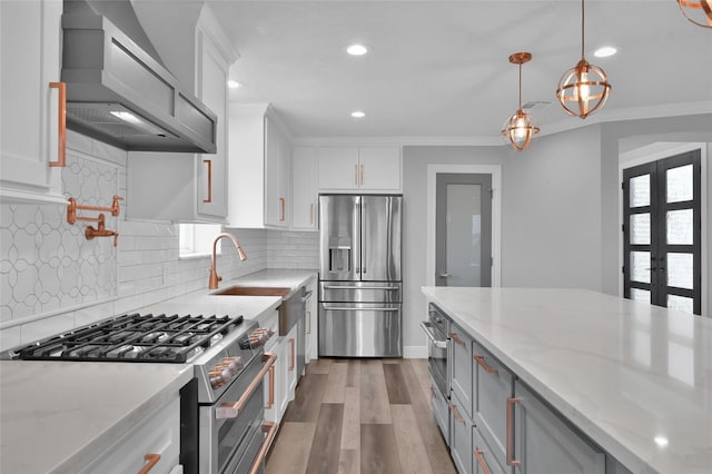 kitchen featuring custom exhaust hood, white cabinetry, appliances with stainless steel finishes, and light stone countertops