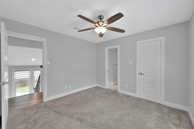 unfurnished room featuring light colored carpet and ceiling fan