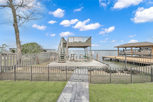 dock area with a water view and a lawn