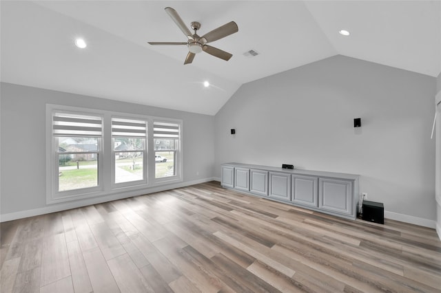 interior space with vaulted ceiling, ceiling fan, and light wood-type flooring