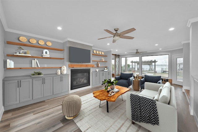 living room featuring ornamental molding and light wood-type flooring