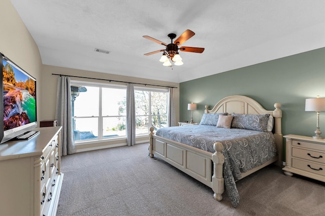 bedroom featuring lofted ceiling, light colored carpet, and ceiling fan