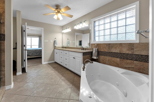 bathroom featuring vanity, tile patterned flooring, a tub, and ceiling fan