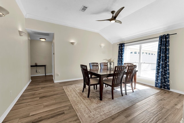 dining area with ornamental molding, lofted ceiling, hardwood / wood-style floors, and ceiling fan