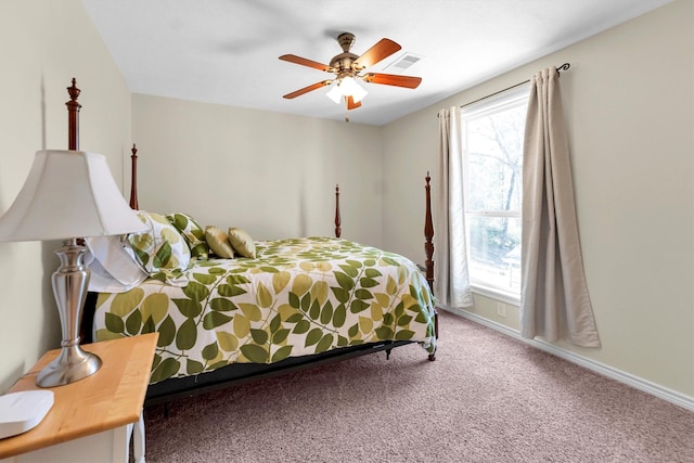 carpeted bedroom with multiple windows and ceiling fan