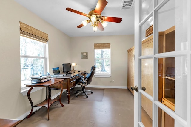 office space with french doors, ceiling fan, and concrete floors