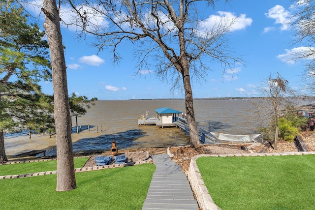 dock area with a water view and a lawn