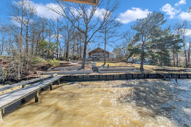 view of dock with a gazebo and a water view