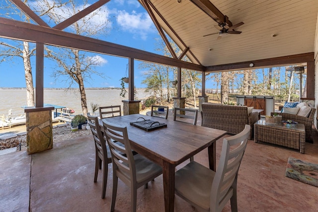 view of patio / terrace featuring a water view, ceiling fan, an outdoor hangout area, and a hot tub