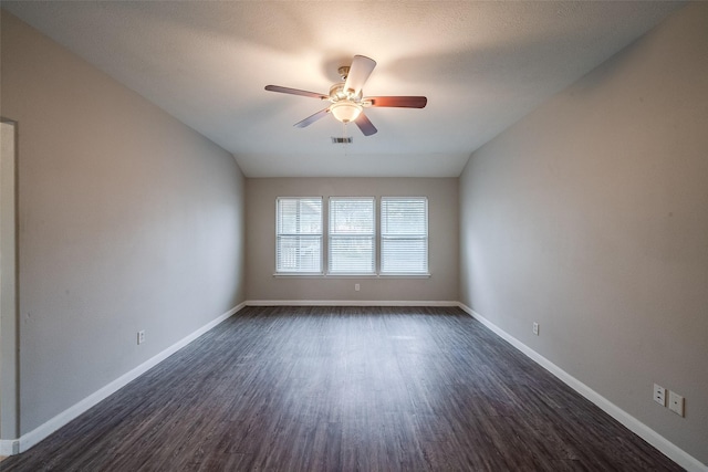 empty room featuring ceiling fan and dark hardwood / wood-style flooring