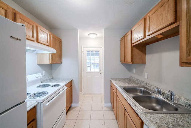 kitchen featuring sink, white appliances, light tile patterned floors, and a textured ceiling