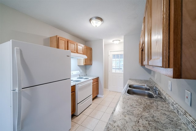 kitchen featuring light tile patterned flooring, sink, and white appliances