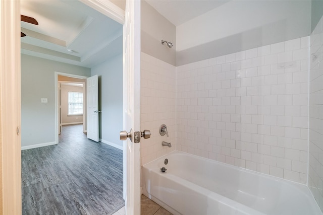 bathroom featuring wood-type flooring and tiled shower / bath combo