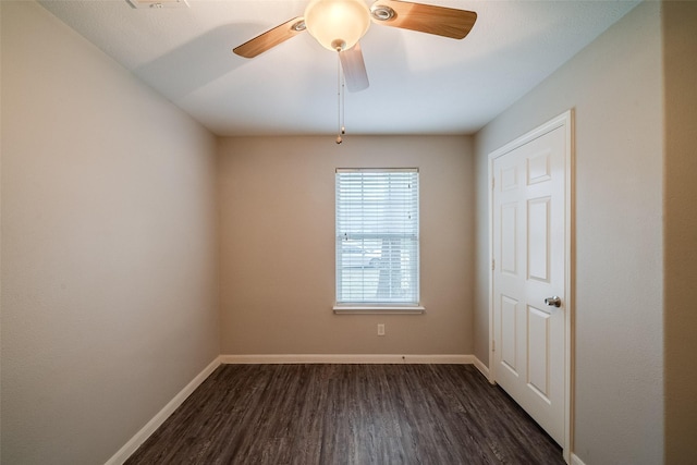 empty room with dark hardwood / wood-style floors and ceiling fan