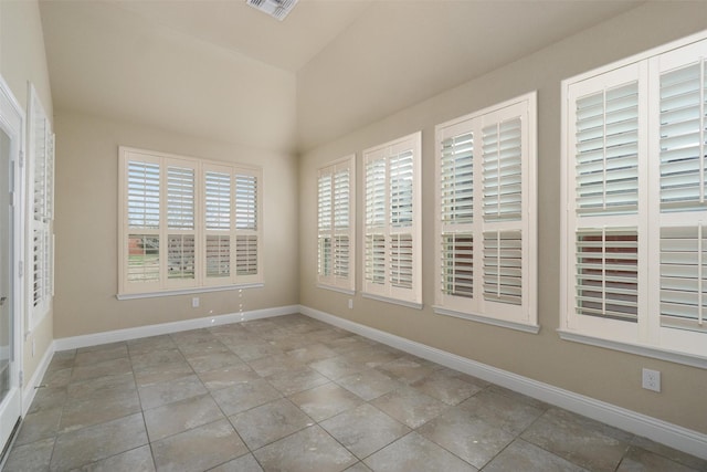 empty room featuring lofted ceiling