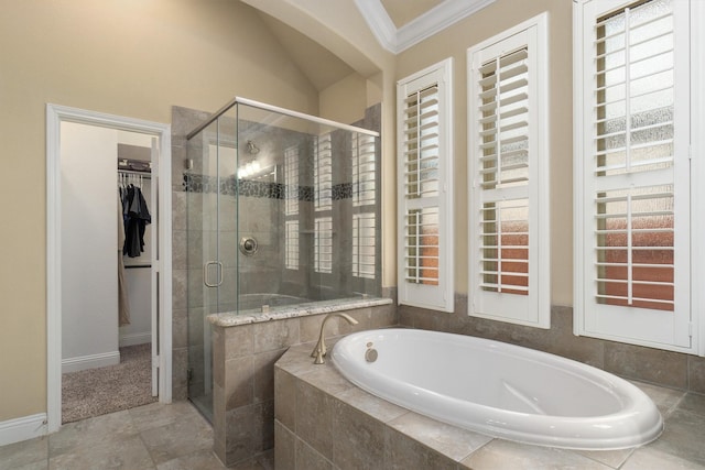 bathroom with crown molding and separate shower and tub