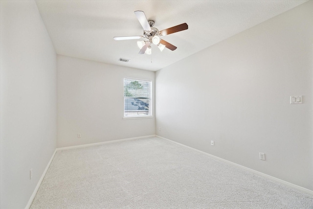 spare room featuring ceiling fan, baseboards, visible vents, and light colored carpet