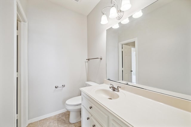 bathroom with vanity, tile patterned flooring, toilet, and an inviting chandelier