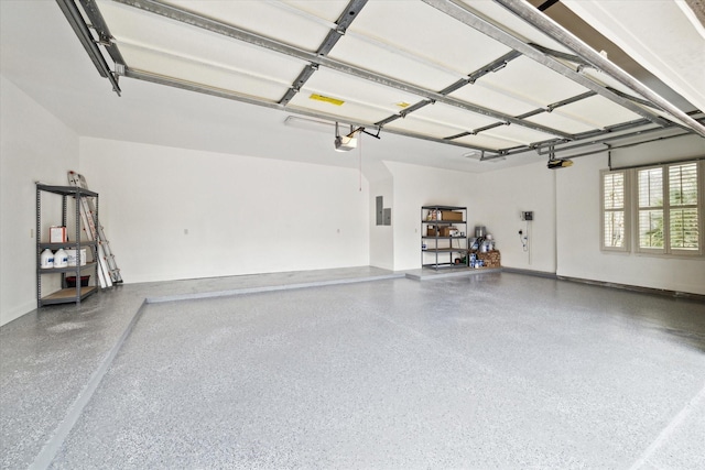 garage with a garage door opener and electric panel