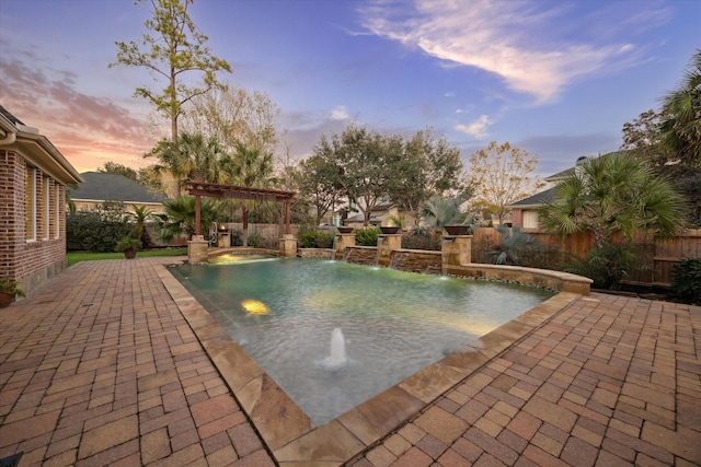 pool at dusk featuring a patio area and a pergola