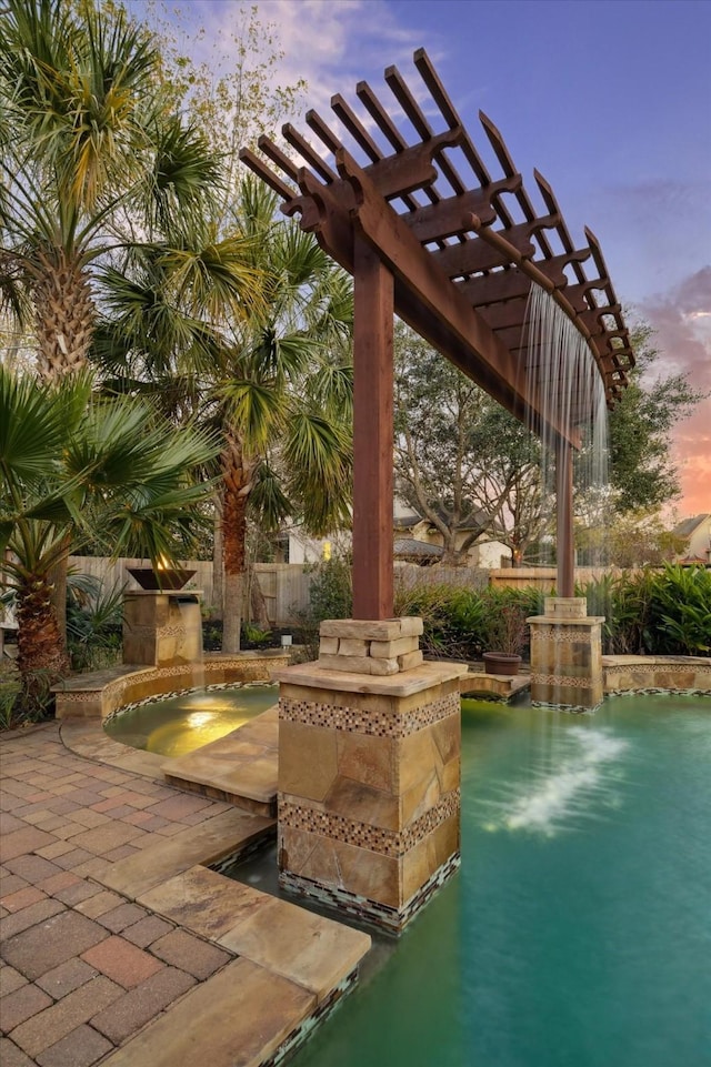 view of patio featuring a fenced in pool, fence, and a pergola