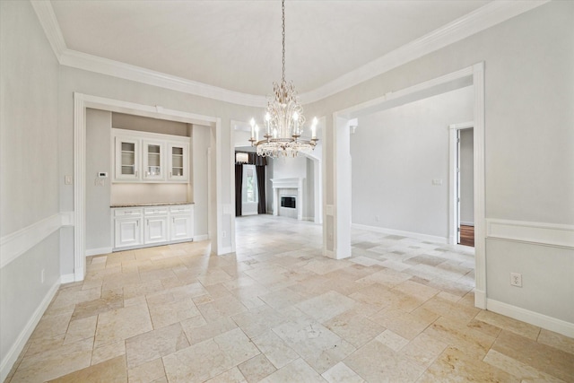 unfurnished dining area featuring an inviting chandelier and ornamental molding