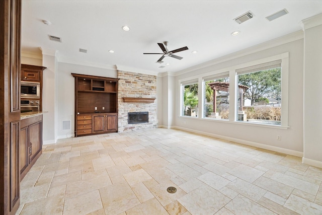 unfurnished living room with stone tile floors, a fireplace, visible vents, and baseboards