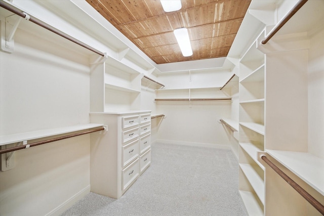 walk in closet featuring light colored carpet