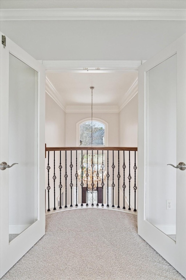 hall with carpet and crown molding