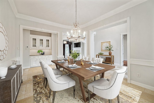 dining space with a notable chandelier, baseboards, and crown molding