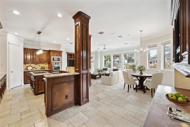 kitchen with tasteful backsplash, stone tile flooring, visible vents, appliances with stainless steel finishes, and light stone countertops