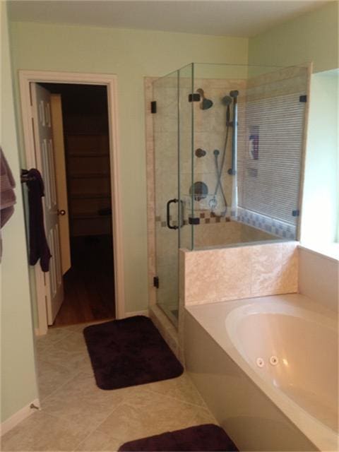 bathroom featuring tile patterned flooring and shower with separate bathtub