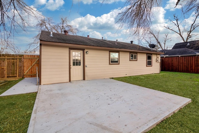 rear view of property featuring a patio and a lawn