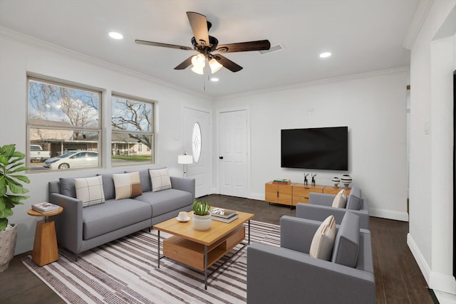 living room with crown molding, dark wood-type flooring, and ceiling fan