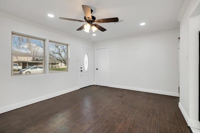 spare room featuring crown molding, dark wood-type flooring, and ceiling fan