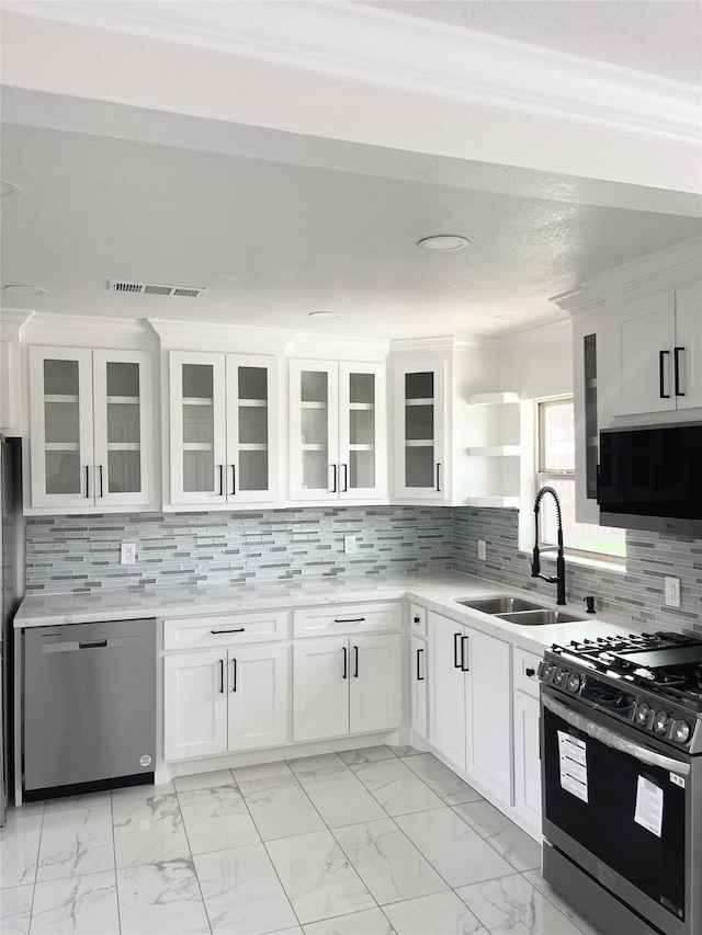 kitchen with white cabinetry, sink, crown molding, and appliances with stainless steel finishes