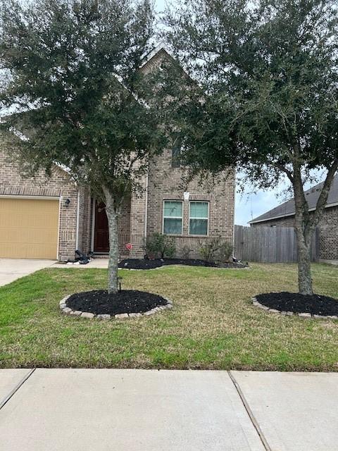 view of front of property with a garage and a front yard