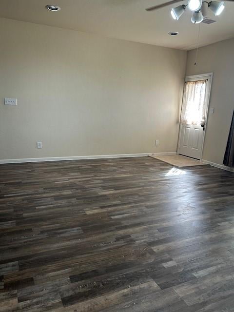 unfurnished room with dark wood-type flooring and ceiling fan