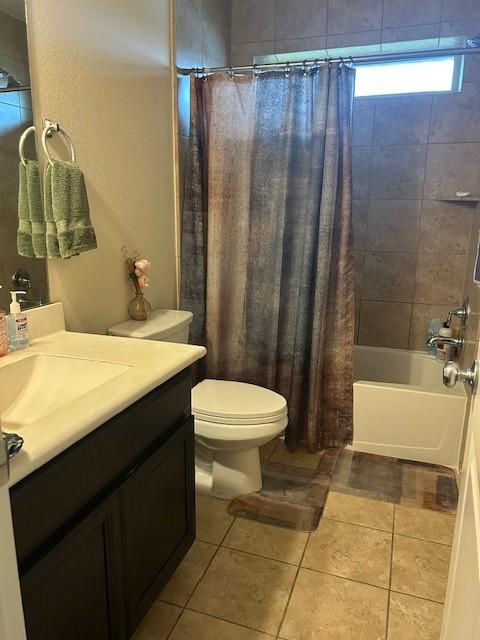 full bathroom with shower / bath combination with curtain, tile patterned floors, toilet, and vanity