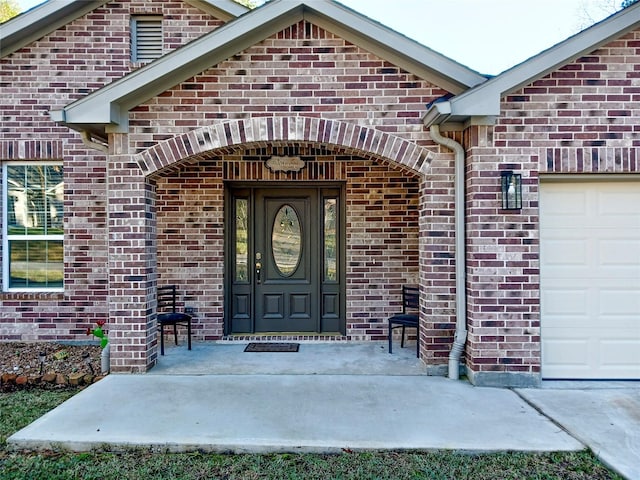 doorway to property featuring a garage and covered porch