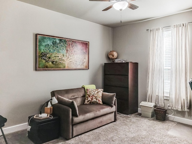 sitting room with ceiling fan and carpet floors