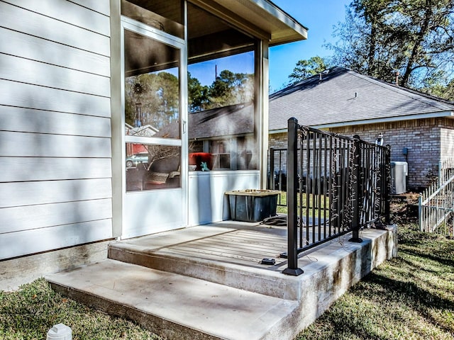 wooden deck featuring central AC unit