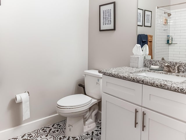 bathroom featuring tiled shower, tile patterned floors, vanity, and toilet