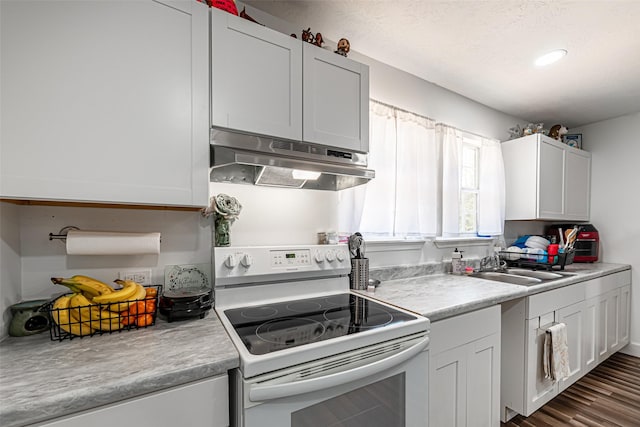 kitchen with white cabinetry, white electric range, and sink