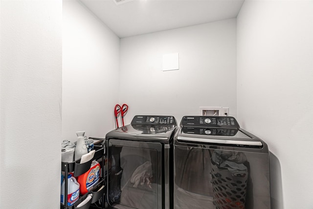 clothes washing area featuring separate washer and dryer