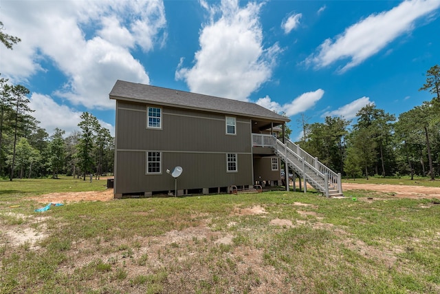 rear view of house featuring a yard