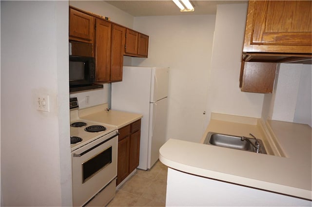 kitchen featuring sink, white appliances, kitchen peninsula, and light tile patterned floors