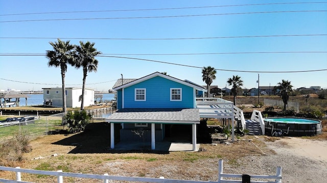 view of front of property with a deck with water view