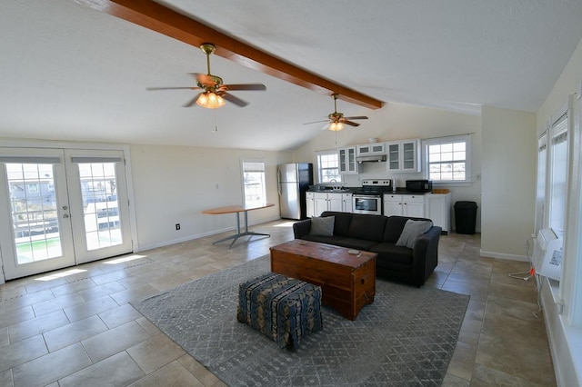 living room with lofted ceiling with beams, a wealth of natural light, and french doors